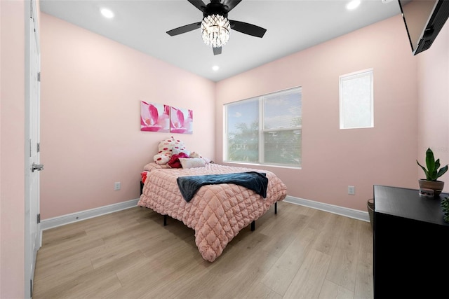 bedroom with ceiling fan and light hardwood / wood-style floors