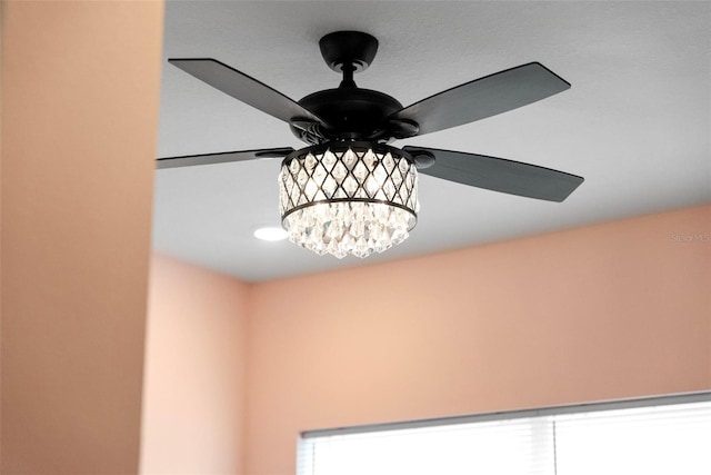 room details with ceiling fan with notable chandelier