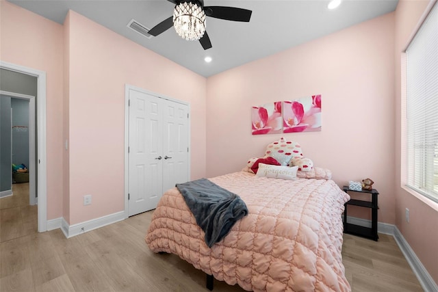 bedroom featuring ceiling fan, a closet, and light wood-type flooring