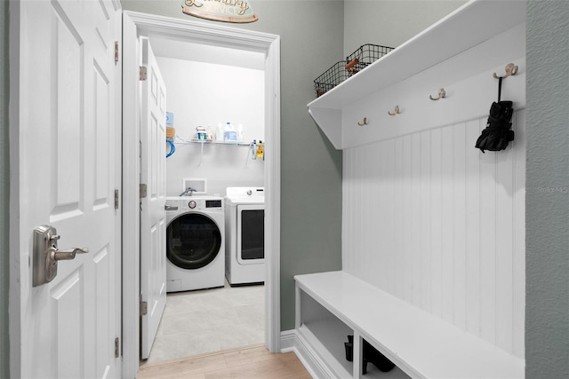 laundry area with separate washer and dryer and light tile patterned flooring