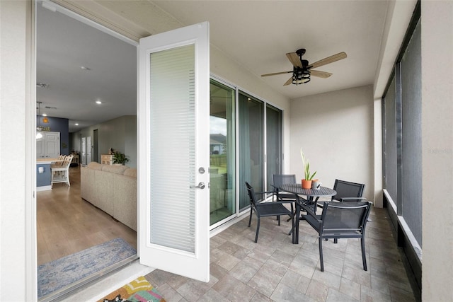 sunroom / solarium featuring ceiling fan