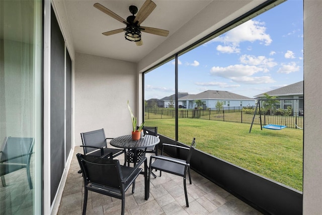 sunroom featuring ceiling fan