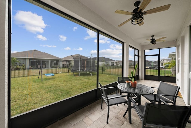 sunroom / solarium featuring ceiling fan