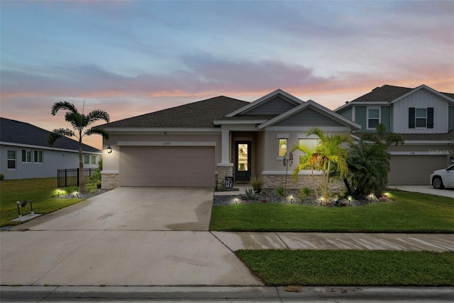 view of front of house with a garage and a lawn