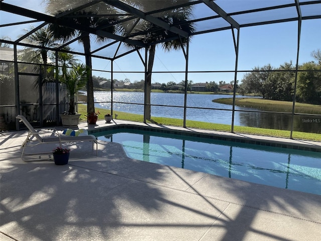 view of swimming pool with a water view, glass enclosure, and a patio area