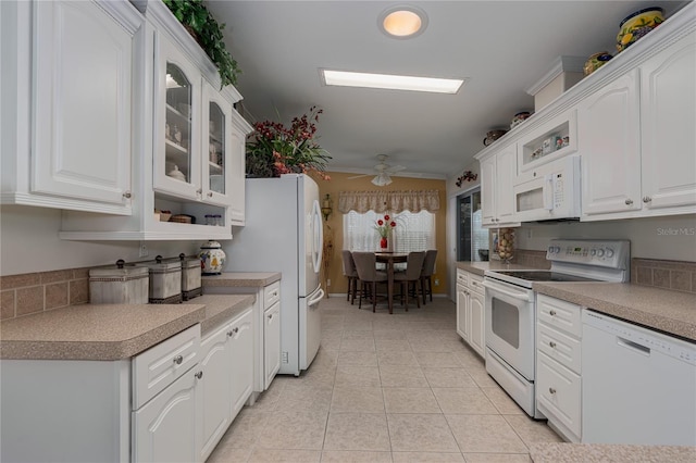 kitchen featuring ceiling fan, light tile patterned floors, white appliances, and white cabinetry