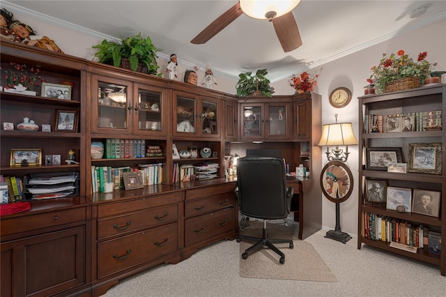 carpeted home office featuring ceiling fan and ornamental molding