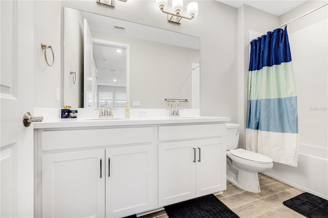 full bathroom featuring toilet, vanity, and shower / tub combo