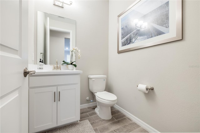 bathroom featuring toilet and vanity