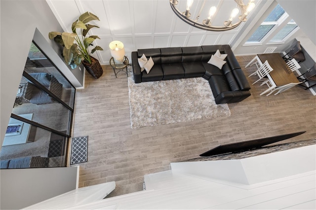 living room with hardwood / wood-style floors and an inviting chandelier