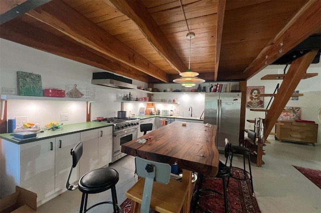 kitchen featuring beam ceiling, stainless steel appliances, decorative light fixtures, white cabinets, and exhaust hood