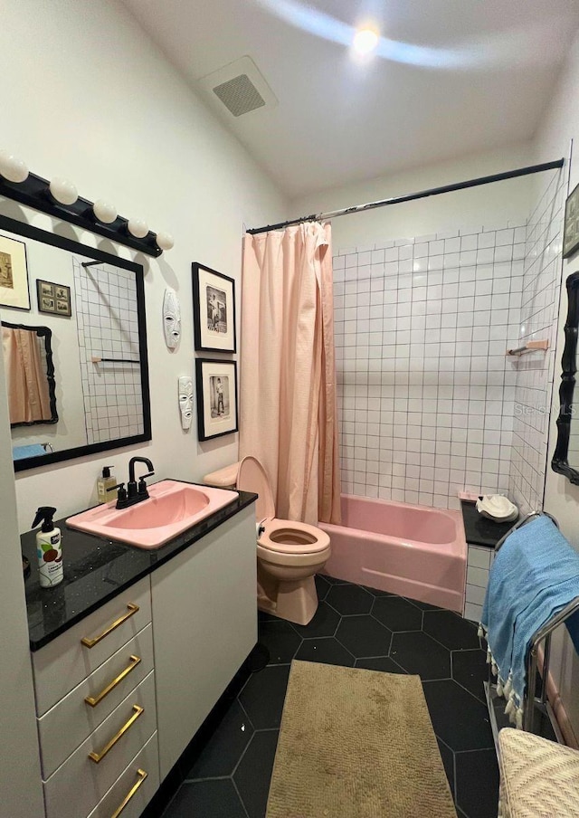 full bathroom featuring tile patterned flooring, vanity, shower / tub combo, and toilet