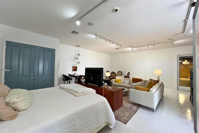 bedroom with a closet and concrete flooring