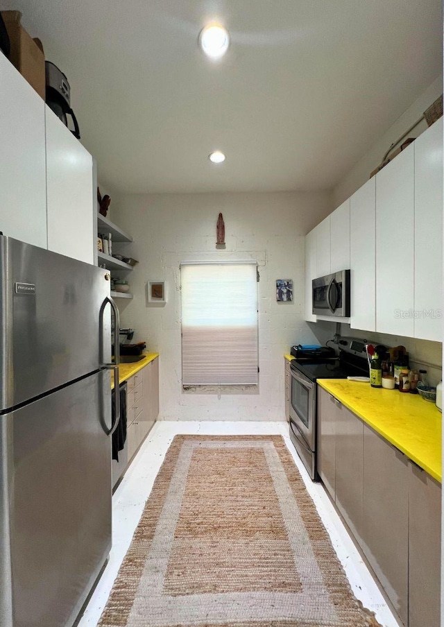 kitchen with white cabinets and appliances with stainless steel finishes