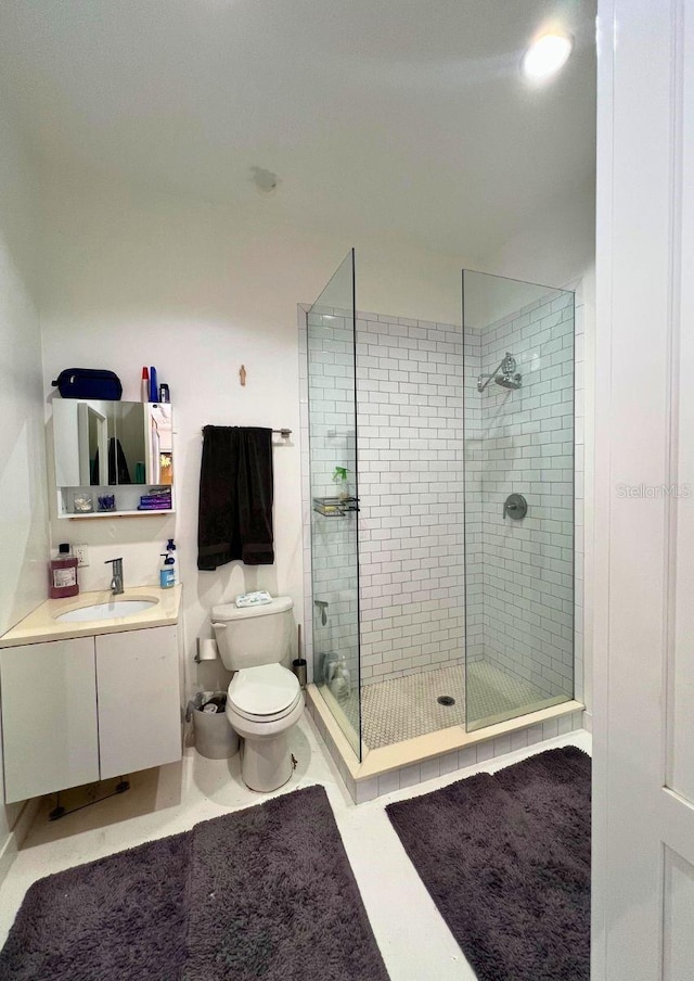 bathroom featuring vanity, toilet, and walk in shower