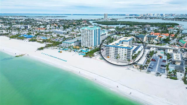 birds eye view of property featuring a view of the beach, a water view, and a view of city