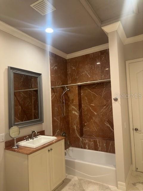 bathroom featuring tiled shower / bath combo, vanity, and crown molding