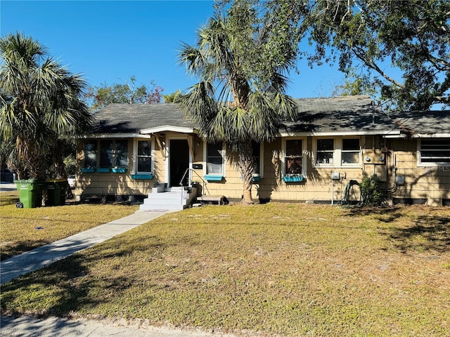 ranch-style home featuring a front yard