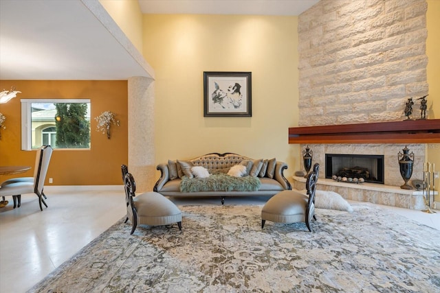 living room with a fireplace and concrete flooring