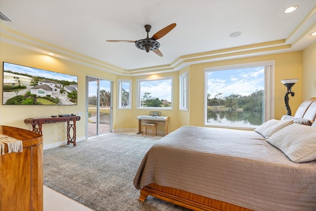 carpeted bedroom with a water view and ceiling fan