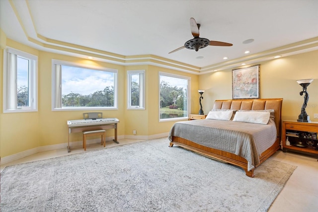 bedroom with ceiling fan and a raised ceiling