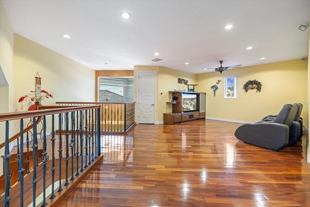 living room featuring ceiling fan and wood-type flooring