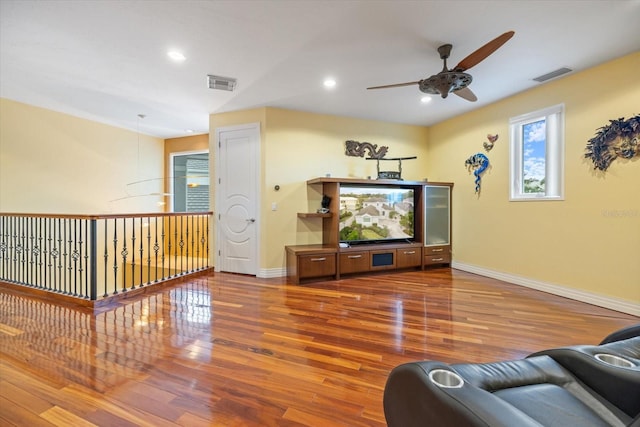 living room featuring ceiling fan and hardwood / wood-style floors