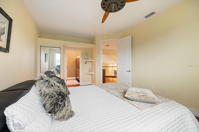 bedroom featuring ceiling fan, ensuite bath, and a closet