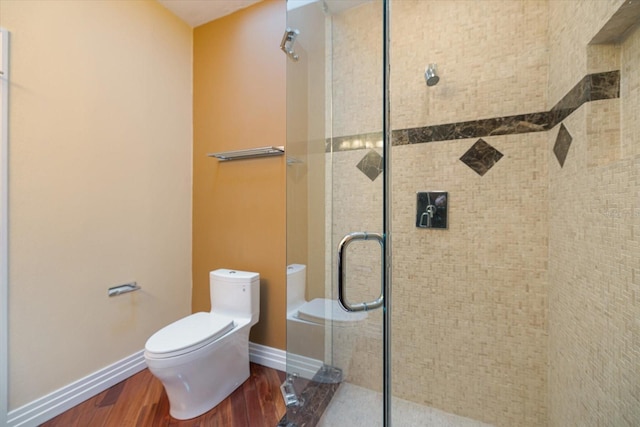 bathroom with wood-type flooring, an enclosed shower, and toilet