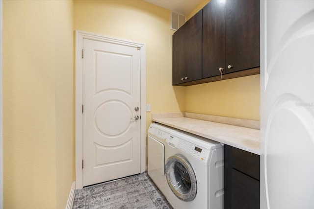 washroom featuring cabinets and independent washer and dryer