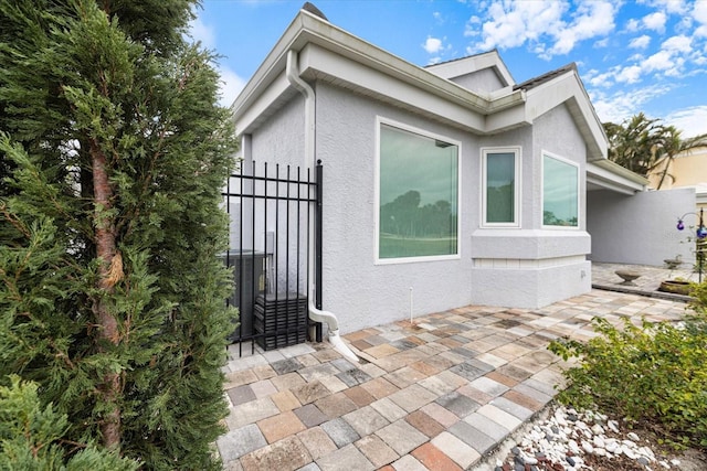 view of home's exterior featuring cooling unit and a patio area