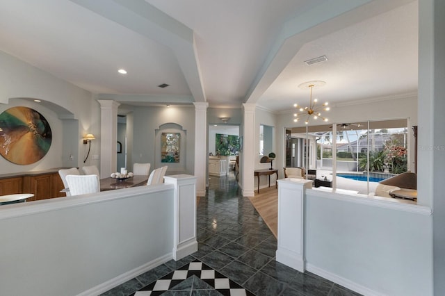 interior space with a chandelier and ornamental molding