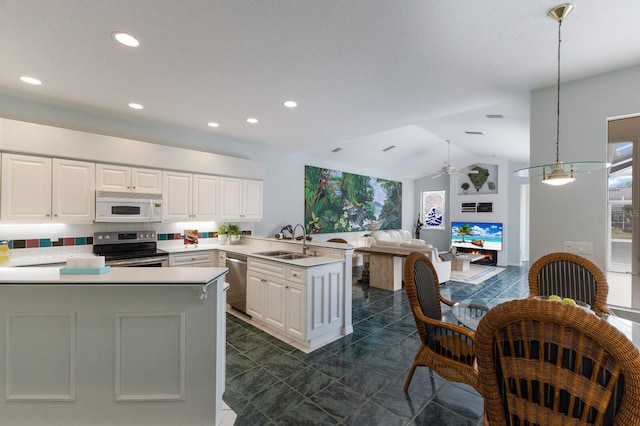 kitchen with appliances with stainless steel finishes, decorative light fixtures, sink, kitchen peninsula, and ceiling fan