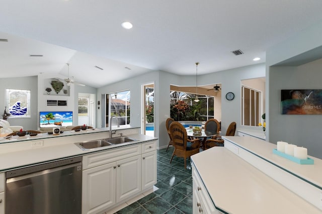 kitchen with white cabinetry, ceiling fan, lofted ceiling, stainless steel dishwasher, and sink