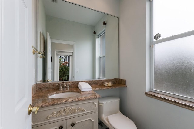 bathroom featuring toilet and vanity