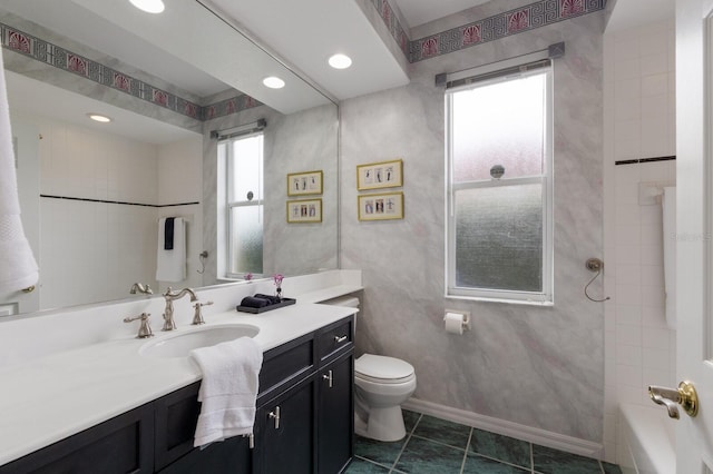 full bathroom featuring toilet, vanity, tiled shower / bath combo, and tile patterned flooring