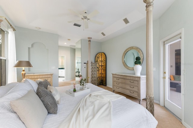 bedroom featuring ceiling fan, access to exterior, and a raised ceiling