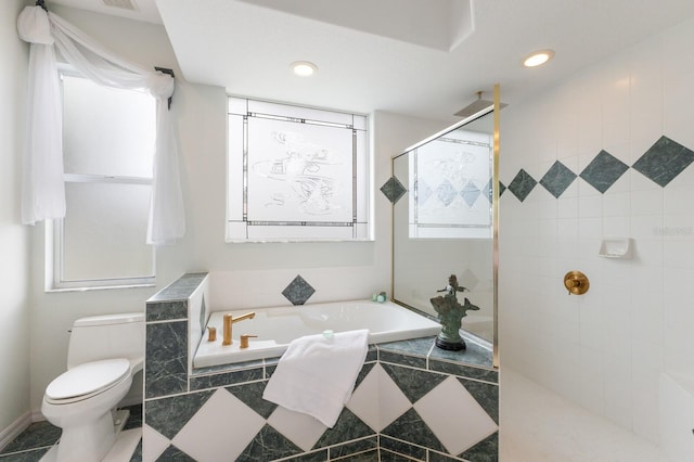 bathroom featuring toilet, separate shower and tub, and a healthy amount of sunlight