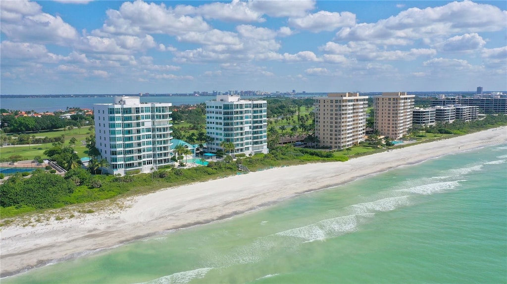 birds eye view of property with a beach view and a water view