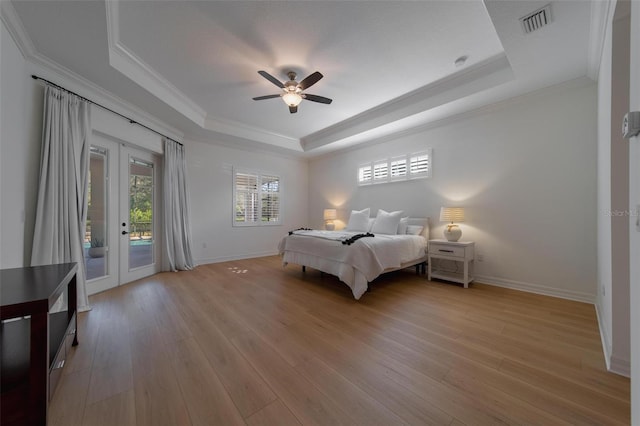 bedroom with a raised ceiling, ceiling fan, ornamental molding, light hardwood / wood-style flooring, and access to outside