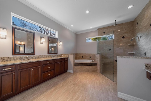 bathroom featuring vanity, crown molding, and plus walk in shower