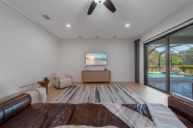 unfurnished living room with light wood-type flooring, ceiling fan, and ornamental molding