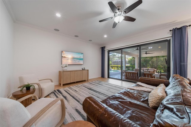 living room with ceiling fan, light wood-type flooring, and crown molding