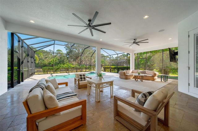 view of patio featuring an outdoor hangout area, ceiling fan, and glass enclosure