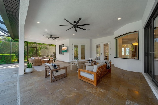 view of patio featuring ceiling fan, french doors, glass enclosure, and outdoor lounge area