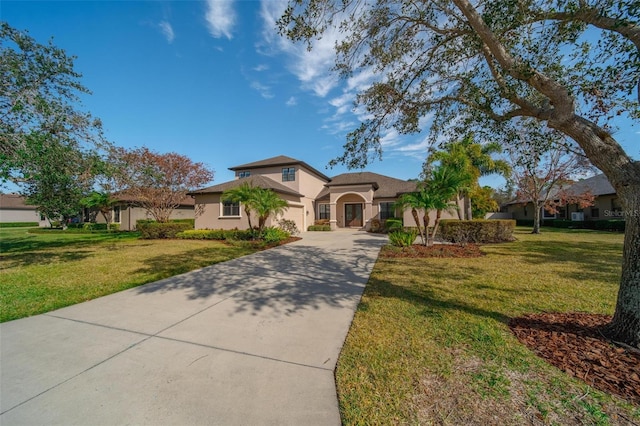 mediterranean / spanish-style home featuring a front yard