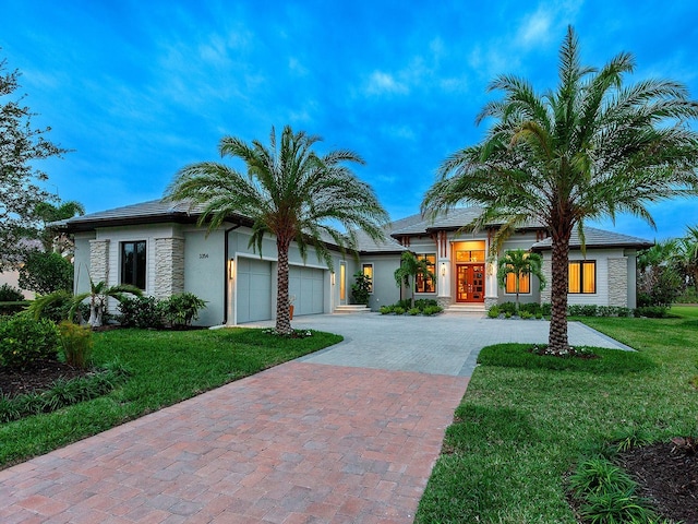 view of front of property with a garage and a front lawn