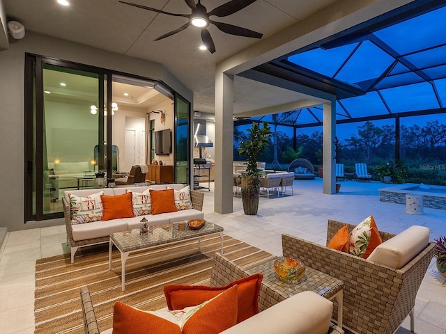 view of patio with an in ground hot tub, ceiling fan, an outdoor hangout area, and glass enclosure