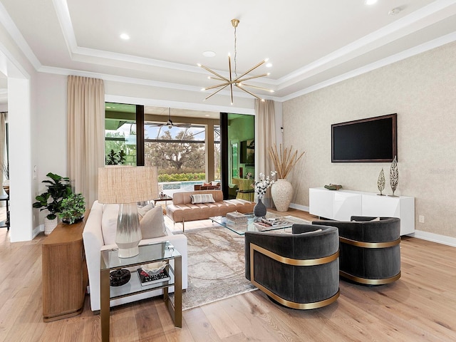 living room with a raised ceiling, wood-type flooring, and crown molding