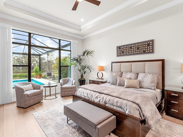 bedroom with ceiling fan, ornamental molding, light hardwood / wood-style floors, access to outside, and a raised ceiling